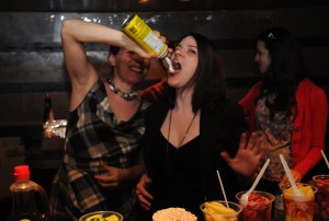 Johanna Nutter feeding Amy Blackmore at the 'Fringlish' buffet
